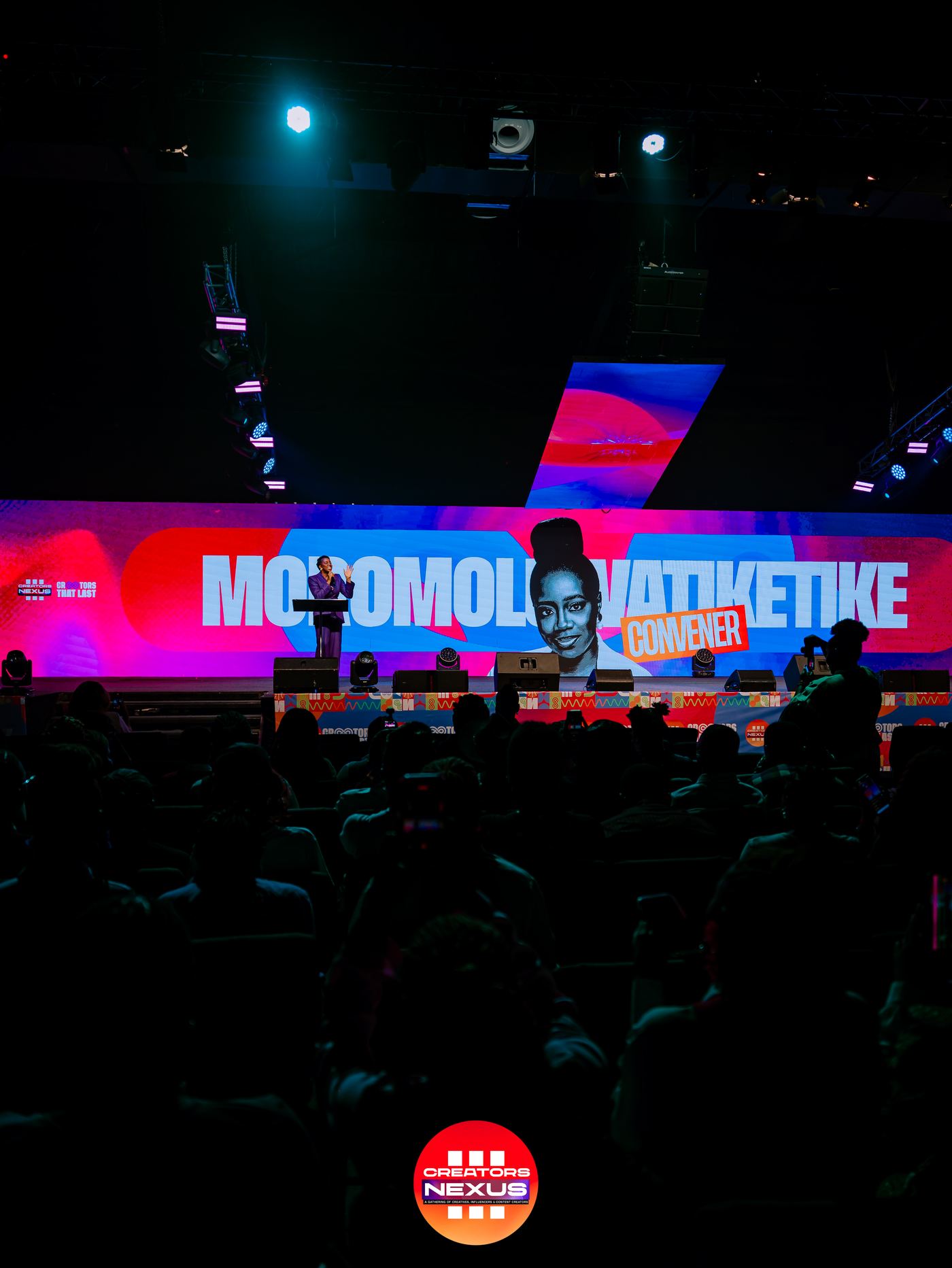 A speaker addressing the room from the Creators Nexus stage.