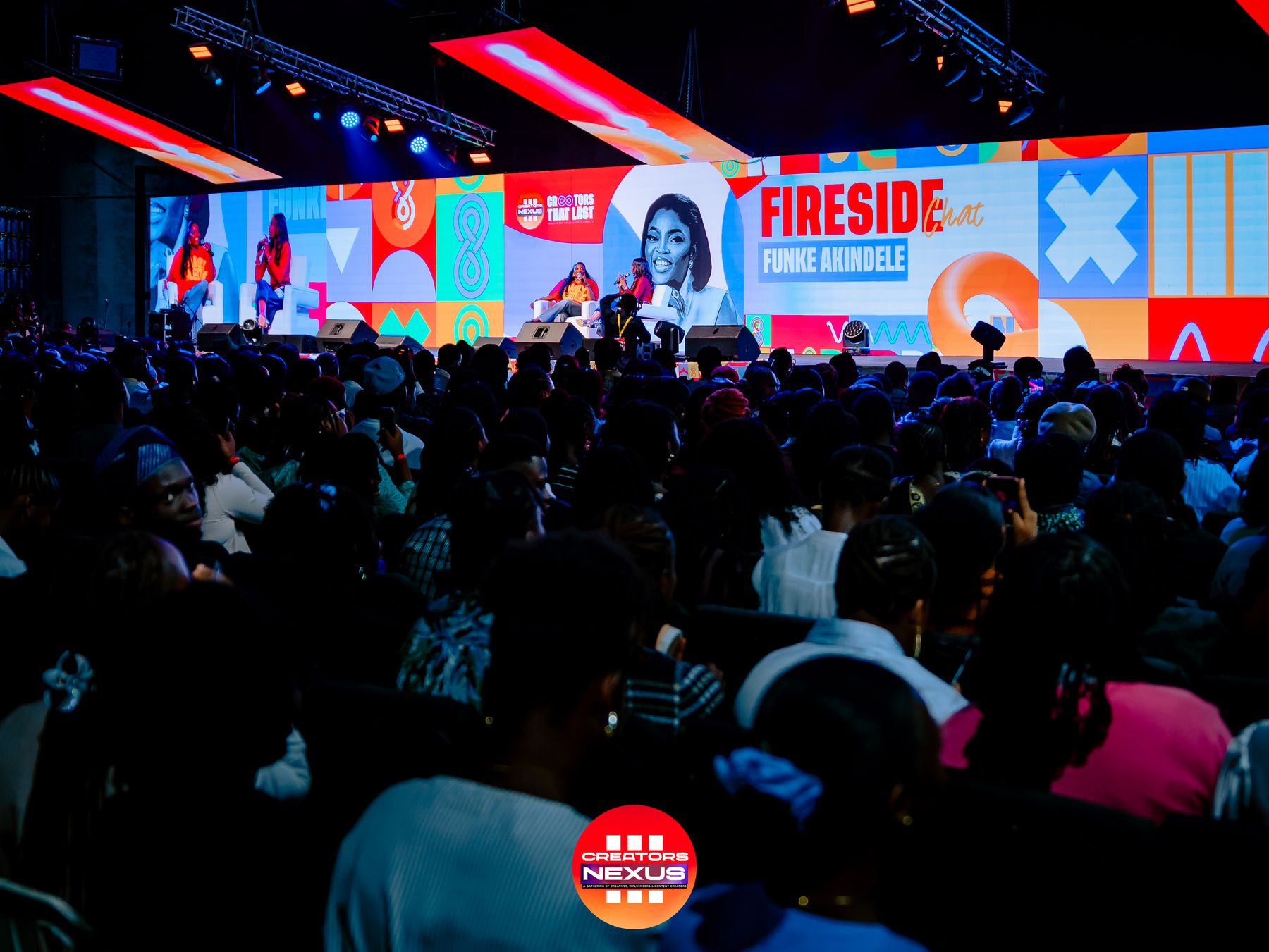 A packed crowd faces the main stage for a Fireside Chat with Funke Akindele at Creators Nexus III.
